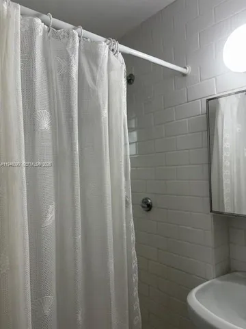 a bathroom with a shower and a sink