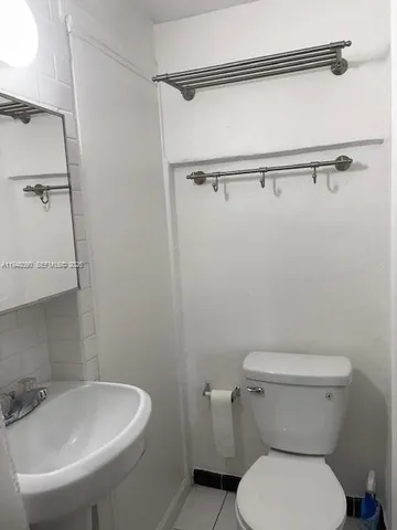 a white toilet sitting next to a bathroom sink