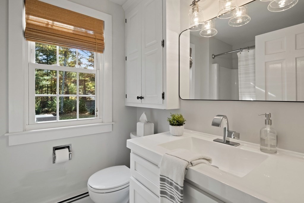 63 West Way Mashpee, MA 02649 - Photo 24 of 41 a bathroom with a sink a toilet and a mirror