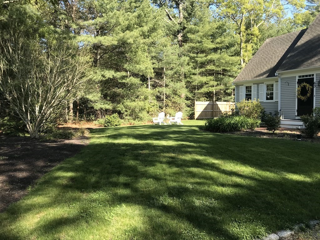63 West Way Mashpee, MA 02649 - Photo 4 of 41 a view of a house with a big yard and potted plants