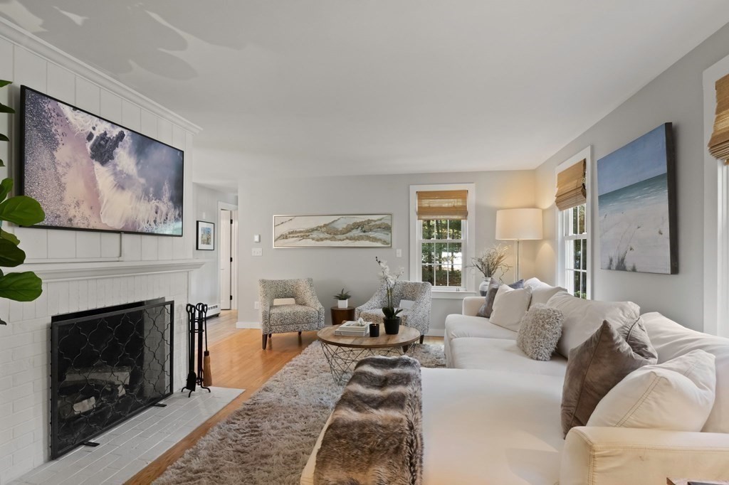 63 West Way Mashpee, MA 02649 - Photo 8 of 41 a living room with furniture a fireplace and a large window