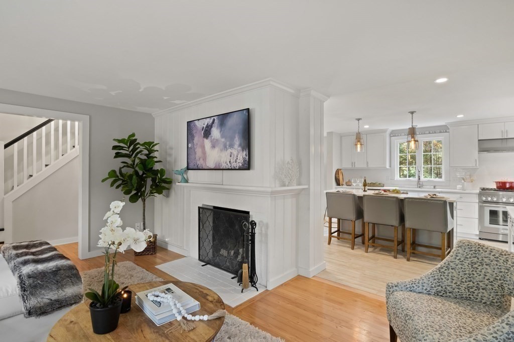 63 West Way Mashpee, MA 02649 - Photo 10 of 41 a living room with furniture a fireplace and a potted plant