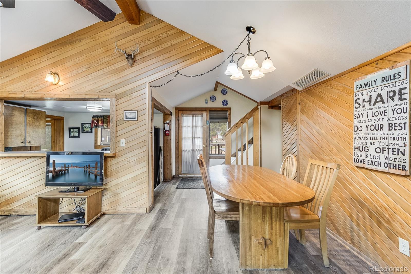 2220 Eagle Cliff Road Estes Park, CO 80517 - Photo 9 of 27 a view of a dining room with furniture and wooden floor