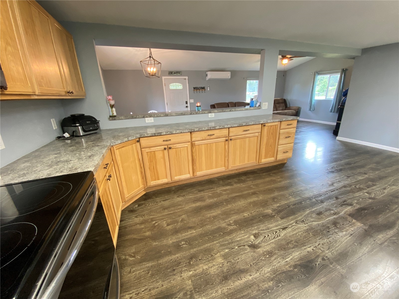 17540 Sargent Road Southwest Rochester, WA 98579 - Photo 8 of 27 a large kitchen with granite countertop a sink and a stove