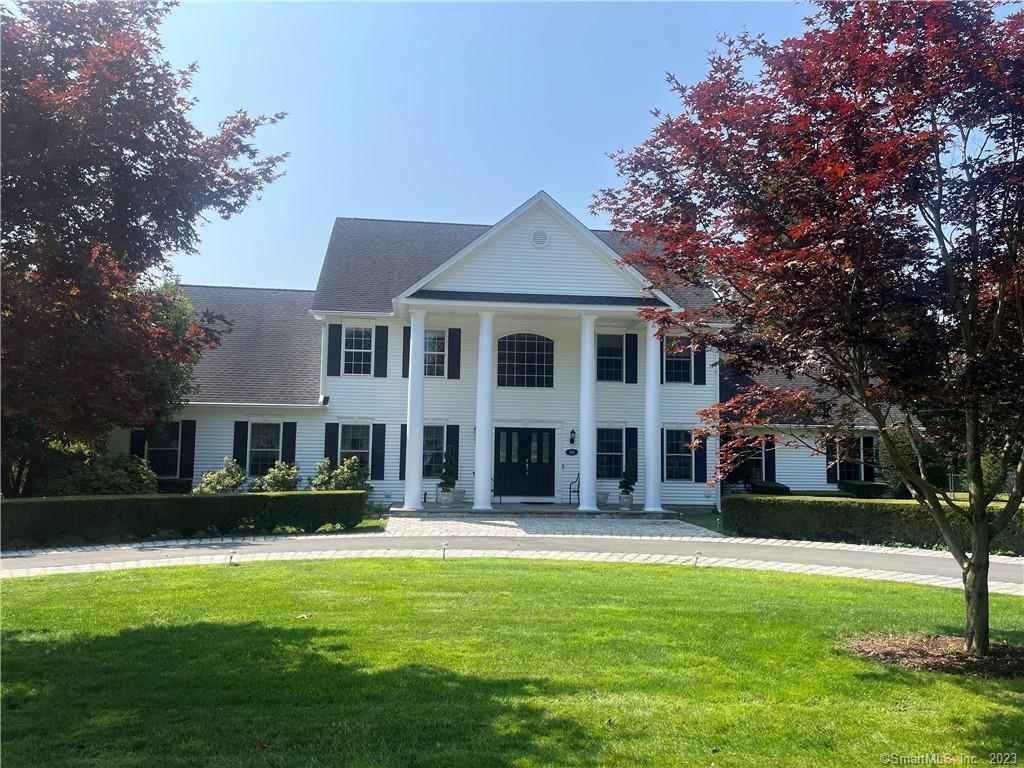 148 Cherry Hill Road Orange, CT 06477 - Photo 1 of 1 a front view of a building with a garden