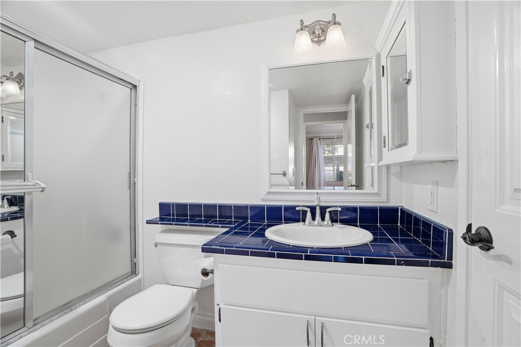 20702 El Toro Road, Unit 231 Lake Forest, CA 92630 - Photo 10 of 36 a bathroom with a sink a toilet and a mirror