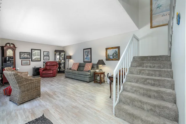 a view of staircase with wooden floor and window