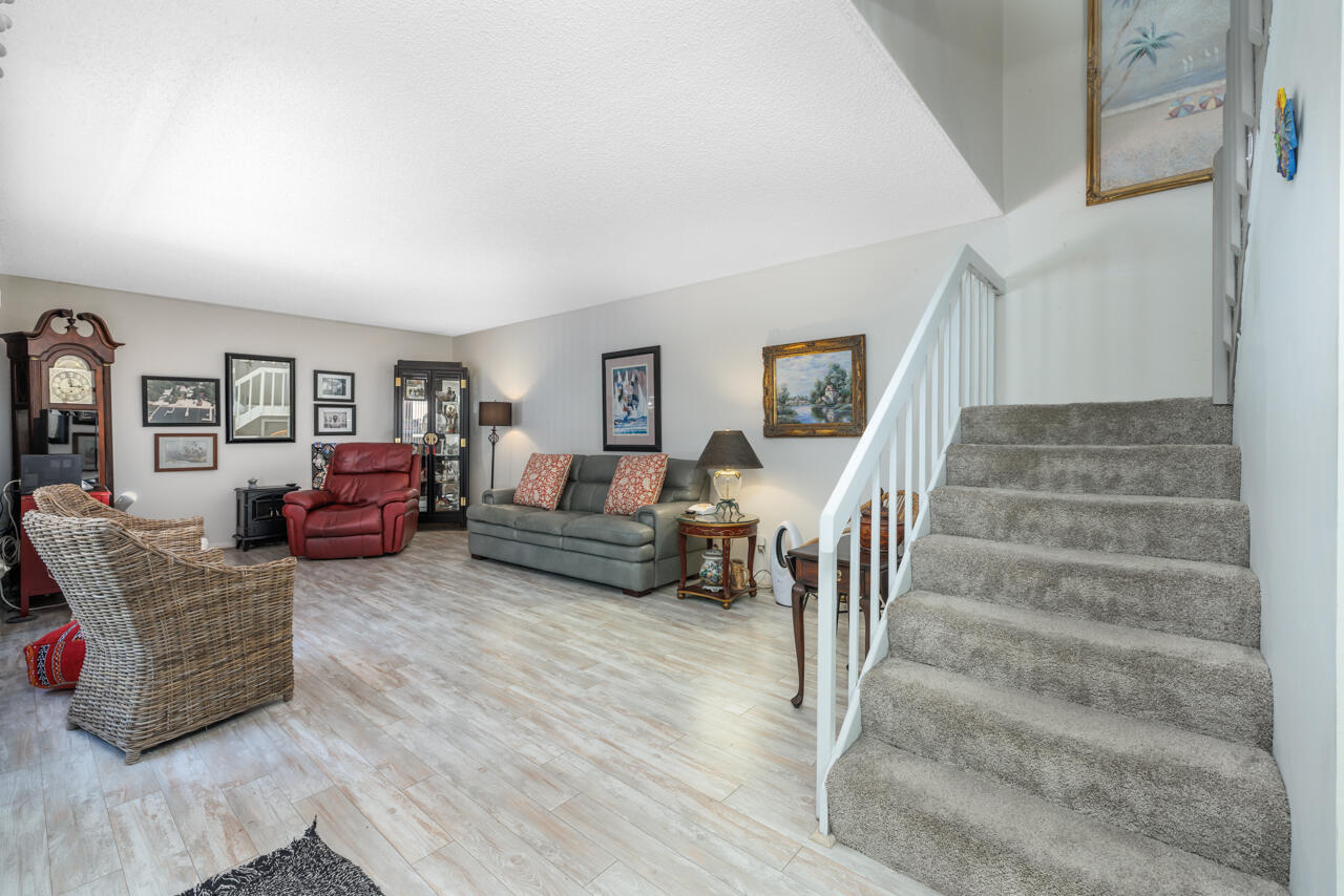 5996 Southeast Riverboat Drive, Unit 539 Stuart, FL 34997 - Photo 13 of 29 a living room with furniture and a wooden floor