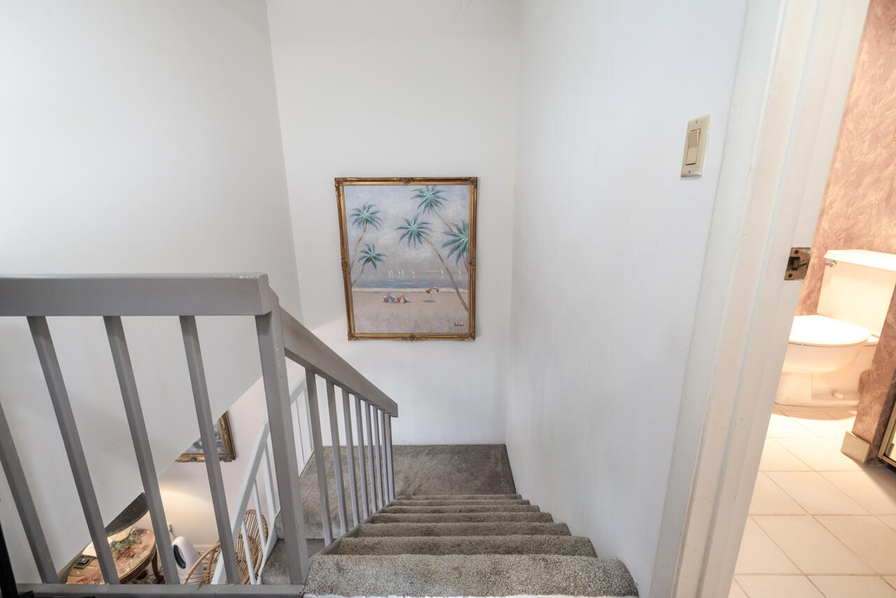 5996 Southeast Riverboat Drive, Unit 539 Stuart, FL 34997 - Photo 14 of 29 a view of staircase with wooden floor and window