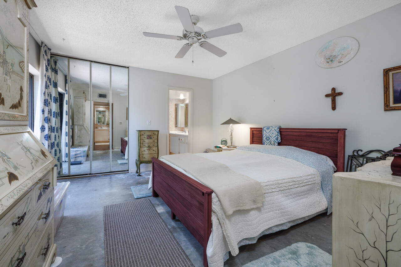 5996 Southeast Riverboat Drive, Unit 539 Stuart, FL 34997 - Photo 15 of 29 a bedroom with a large bed and furniture