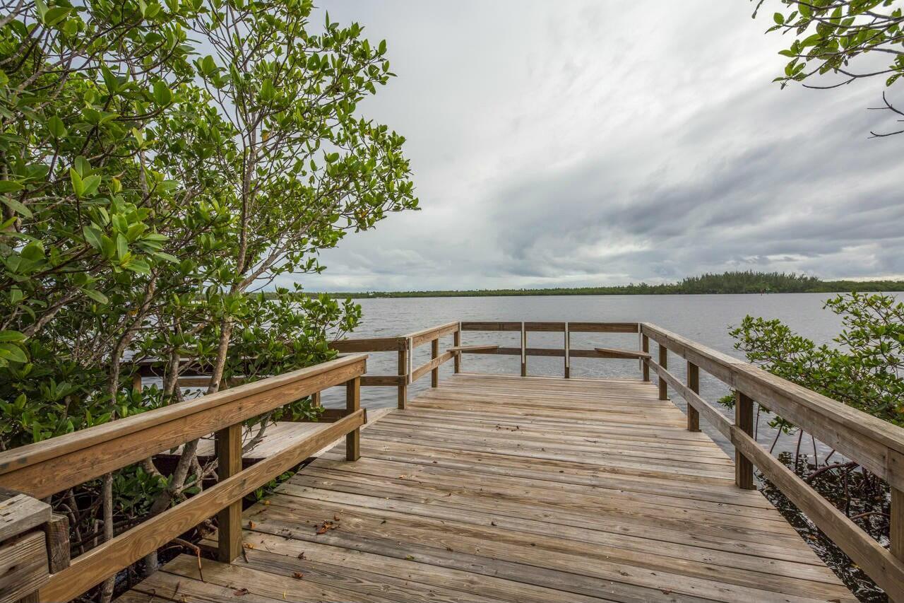 5996 Southeast Riverboat Drive, Unit 539 Stuart, FL 34997 - Photo 23 of 29 a view of a balcony with wooden chairs and floor