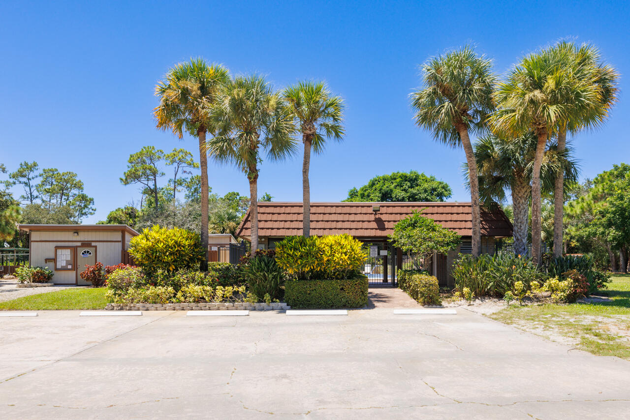 5996 Southeast Riverboat Drive, Unit 539 Stuart, FL 34997 - Photo 24 of 29 a view of a garden with a bench