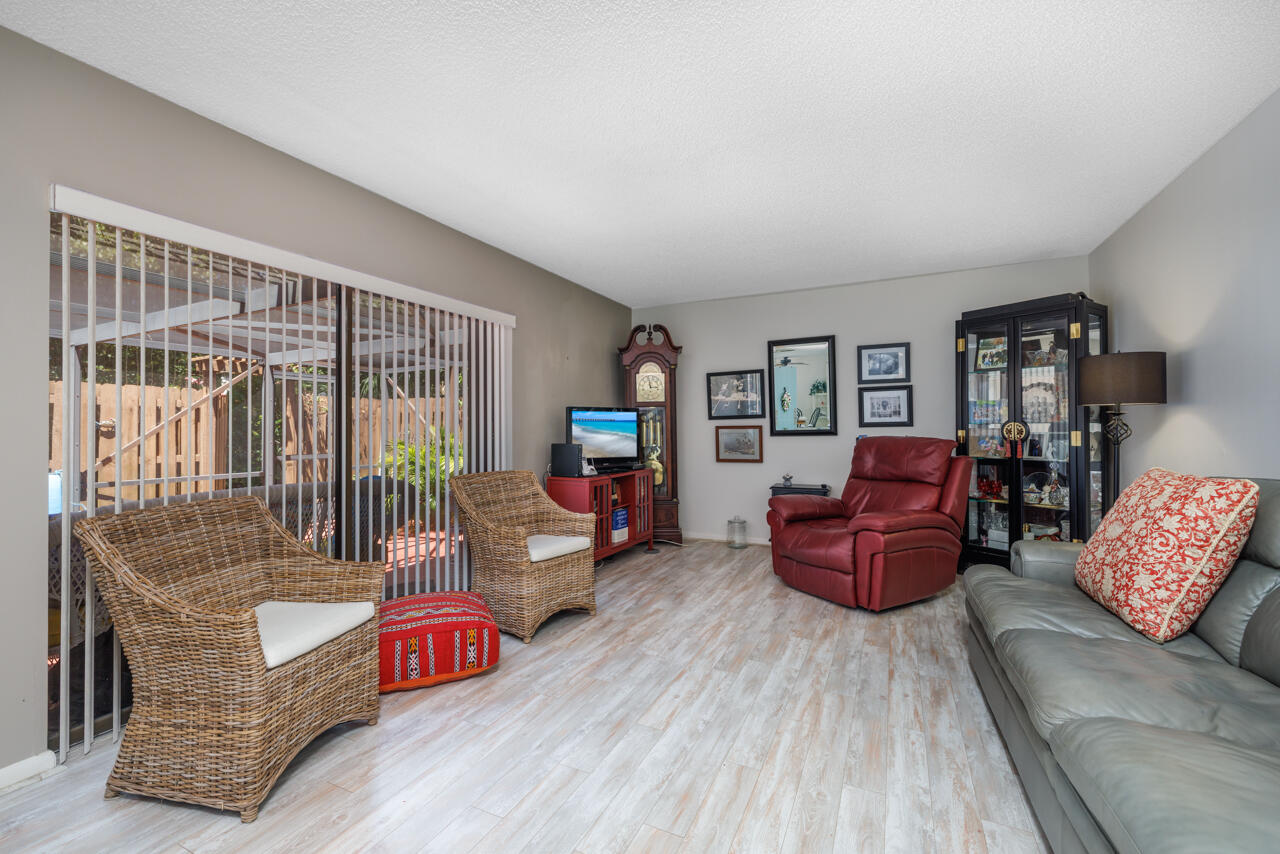 5996 Southeast Riverboat Drive, Unit 539 Stuart, FL 34997 - Photo 6 of 29 a living room with furniture and a wooden floor