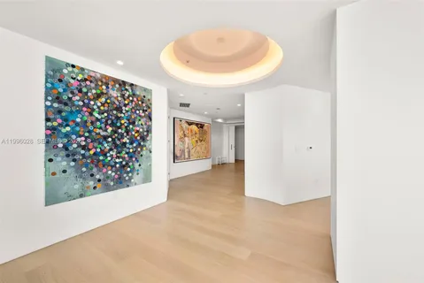 a kitchen with kitchen island a dining table chairs cabinets and stainless steel appliances