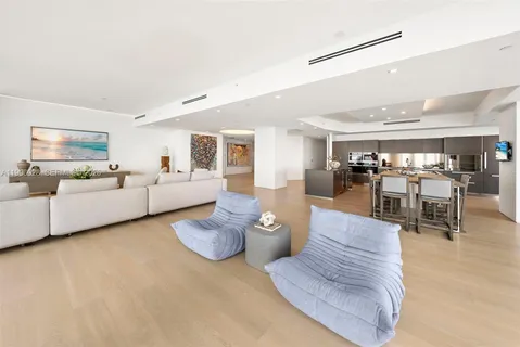 a dining area with stainless steel appliances a table and chairs in it