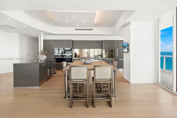 a kitchen with kitchen island a sink appliances and cabinets