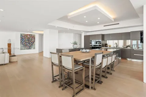 a kitchen with kitchen island granite countertop lots of counter top space and stainless steel appliances