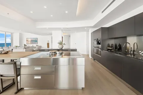 a kitchen with a sink cabinets and stainless steel appliances