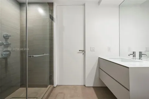 a bedroom with a large bed and a large window