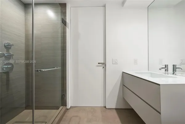 a bedroom with a large bed and a large window