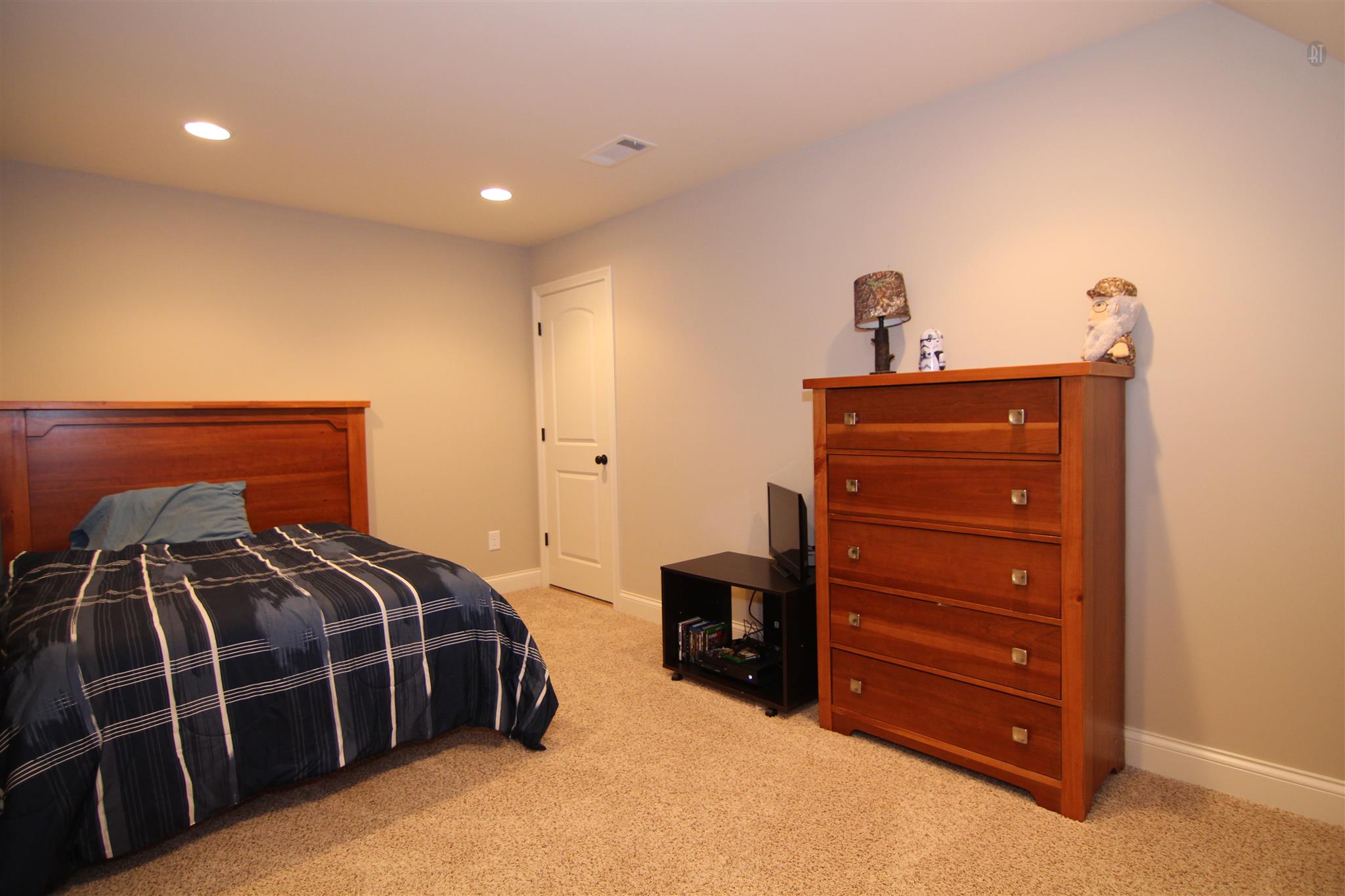704 Academy Road Lebanon, TN 37087 - Photo 12 of 16 a bedroom with a bed and a mirror