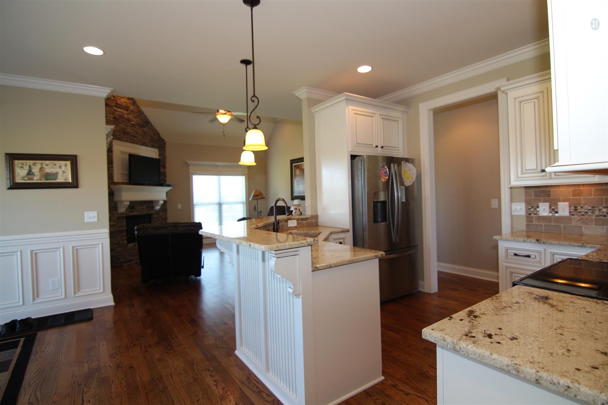704 Academy Road Lebanon, TN 37087 - Photo 5 of 16 a kitchen with stainless steel appliances granite countertop a refrigerator a stove top oven a sink dishwasher and a dining table with wooden floor