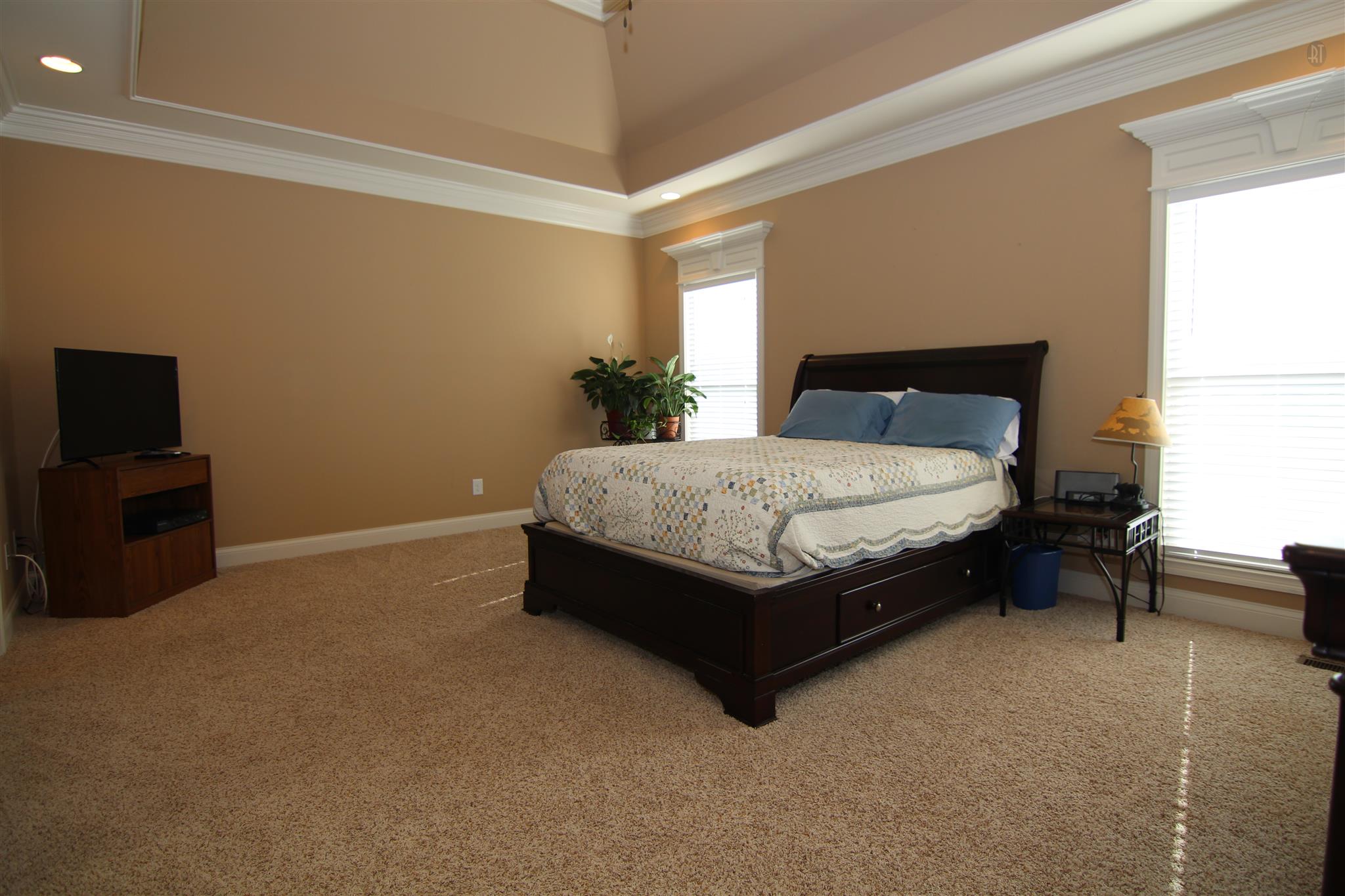 704 Academy Road Lebanon, TN 37087 - Photo 7 of 16 a bed sitting in a bedroom next to a window with lamp