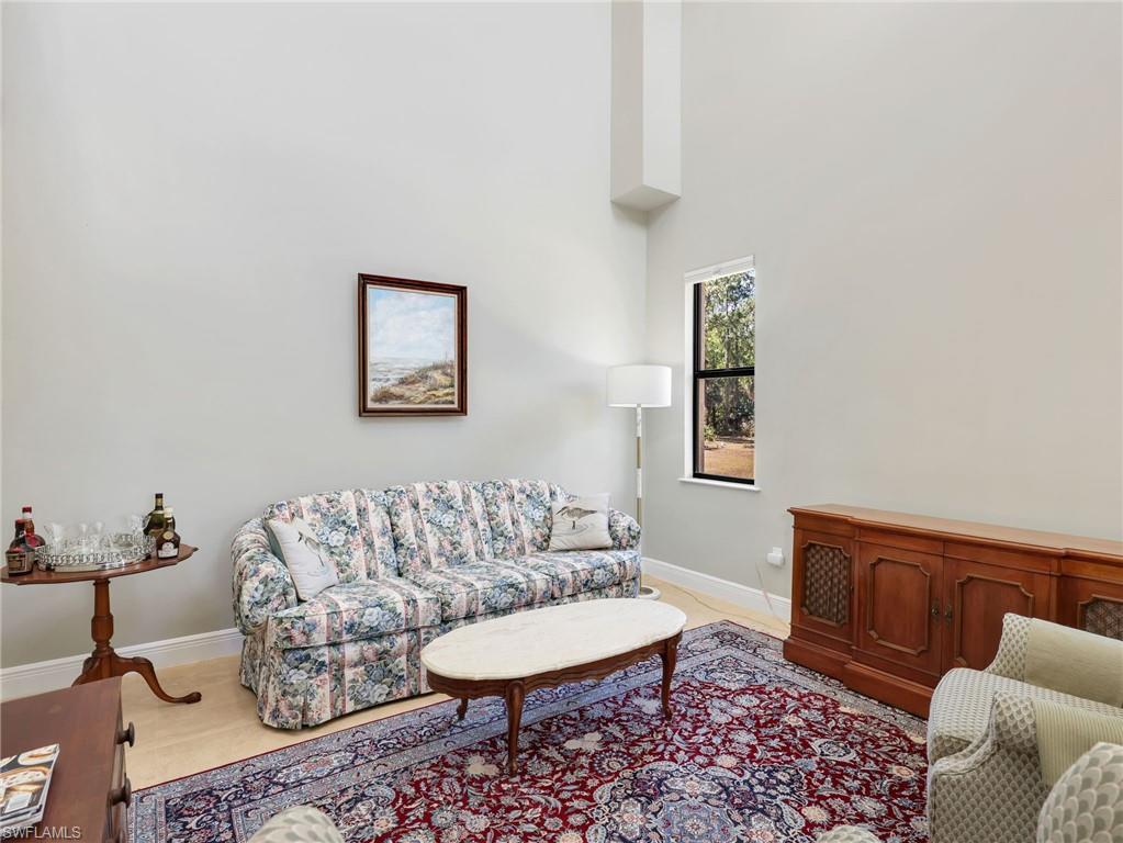 3160 27th Avenue Southwest Naples, FL 34117 - Photo 22 of 43 a living room with furniture and a rug