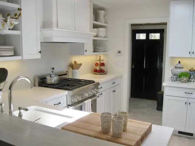 a kitchen with stainless steel appliances granite countertop a stove a sink and a refrigerator