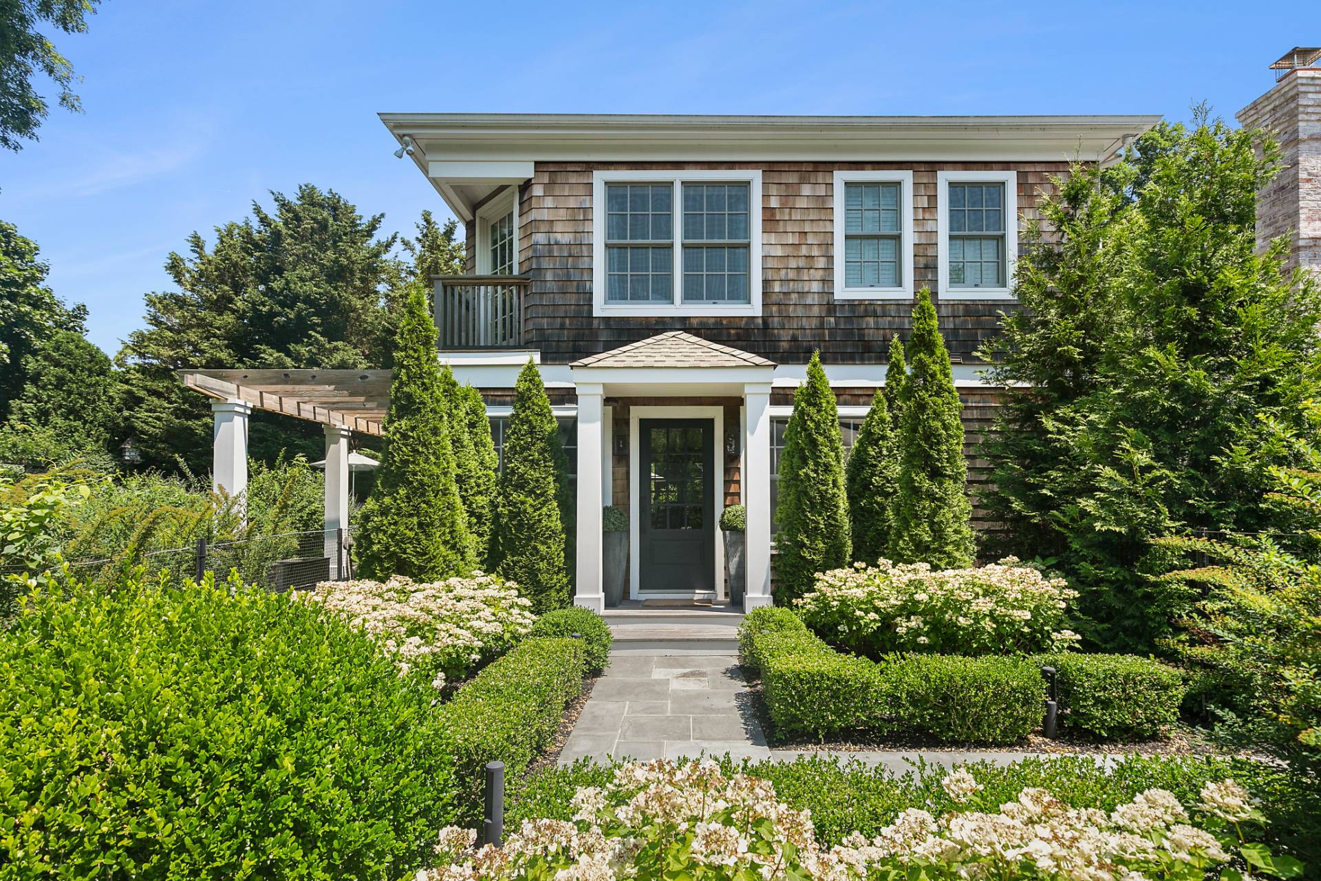 35 Harris Lane Southampton, NY 11968 - Photo 2 of 17 front view of a house with a large window and potted plants