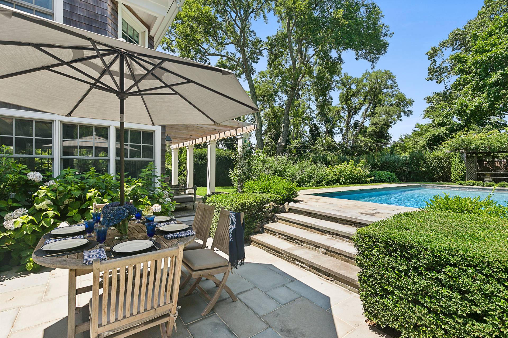 35 Harris Lane Southampton, NY 11968 - Photo 4 of 17 a view of a chair and table in backyard with potted plants