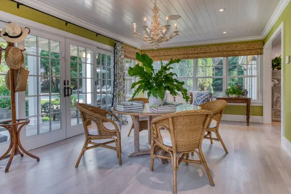 a dining room with furniture a chandelier and wooden floor