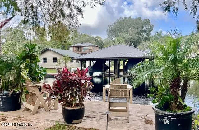 a view of a patio with chairs and plants
