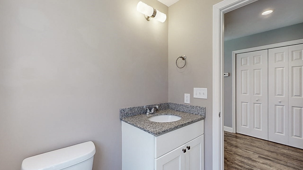 577 Podunk Road East Brookfield, MA 01515 - Photo 15 of 42 a bathroom with a granite countertop sink and a toilet