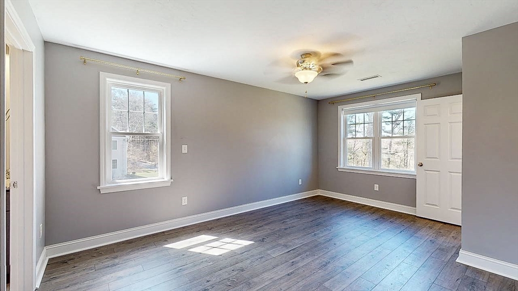 577 Podunk Road East Brookfield, MA 01515 - Photo 19 of 42 a view of an empty room with window and wooden floor