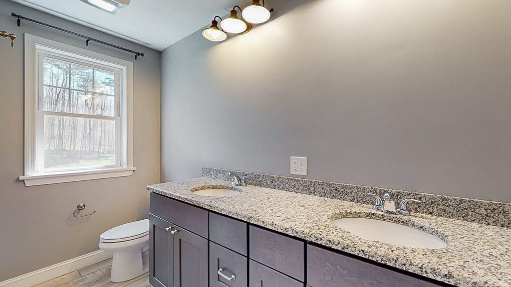 577 Podunk Road East Brookfield, MA 01515 - Photo 20 of 42 a bathroom with a granite countertop sink and a toilet