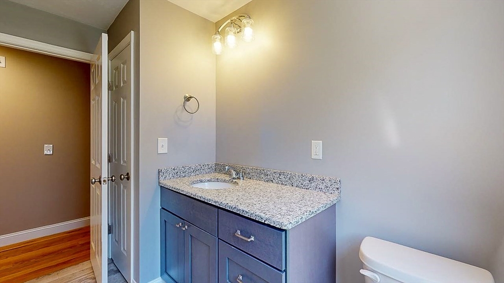 577 Podunk Road East Brookfield, MA 01515 - Photo 30 of 42 a bathroom with a granite countertop sink and a mirror
