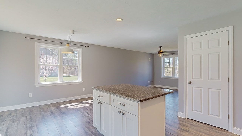 577 Podunk Road East Brookfield, MA 01515 - Photo 4 of 42 an empty room with wooden floor and window
