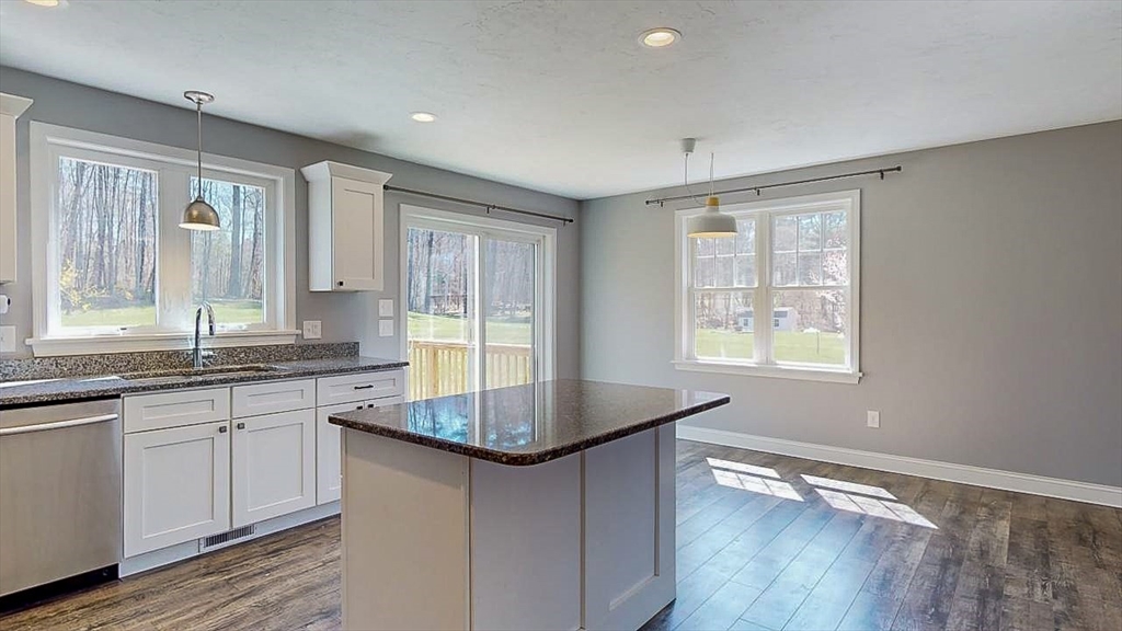 577 Podunk Road East Brookfield, MA 01515 - Photo 5 of 42 a kitchen with granite countertop a sink and cabinets