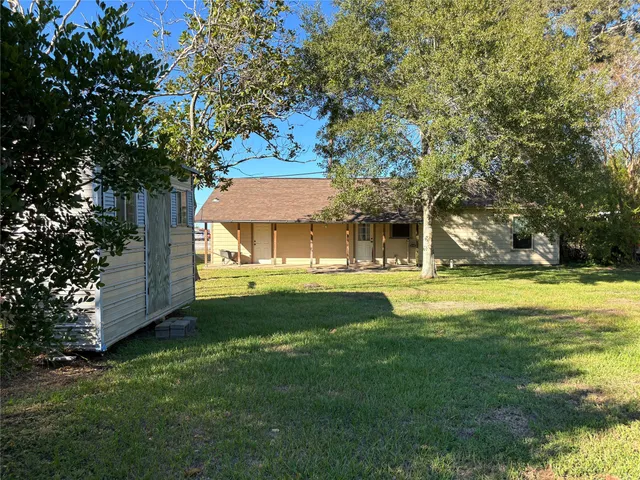 a view of a house with backyard porch and sitting area