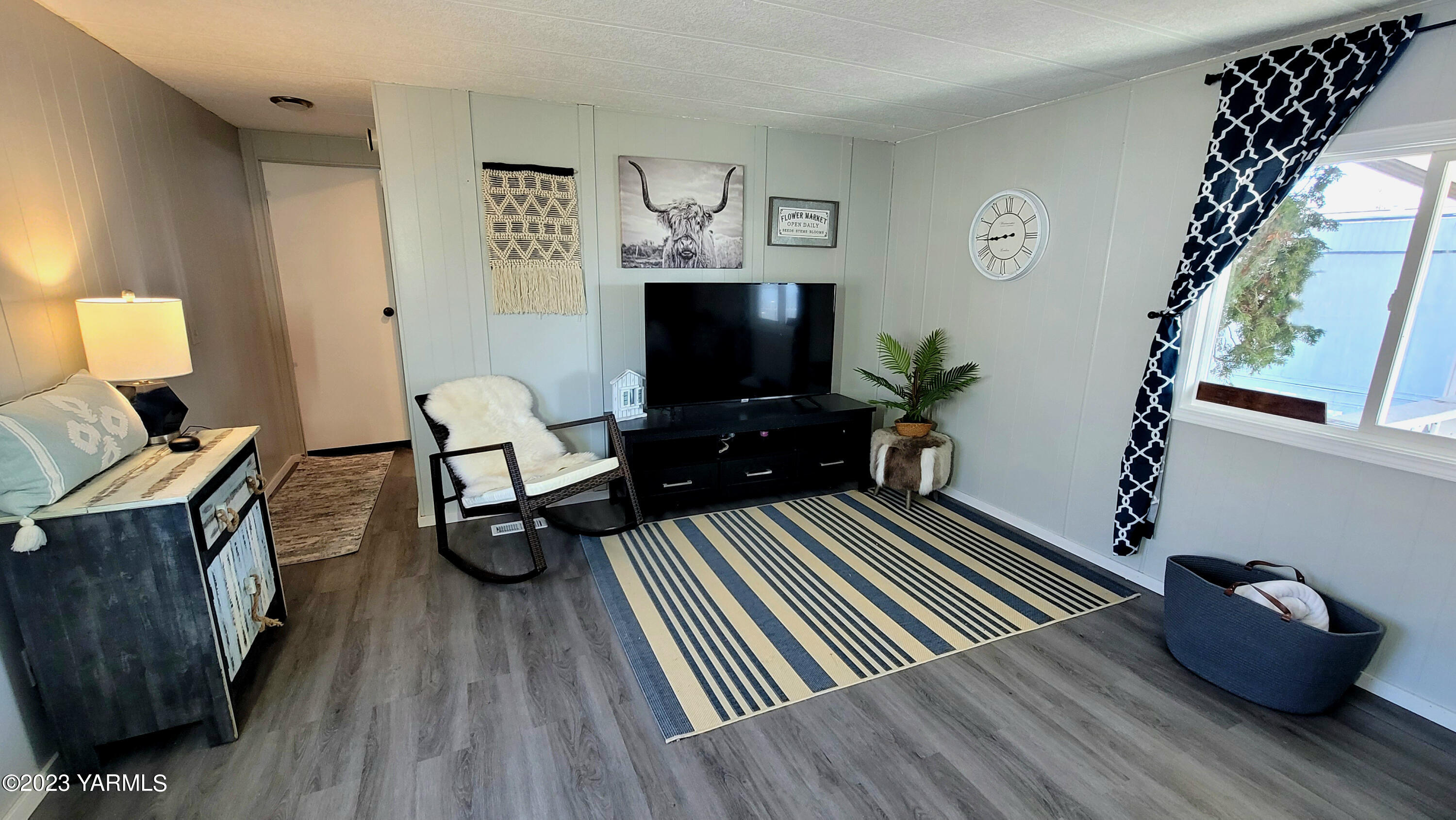 3005 Castlevale Road, Unit 26 Yakima, WA 98902 - Photo 2 of 12 a living room with furniture and a flat screen tv