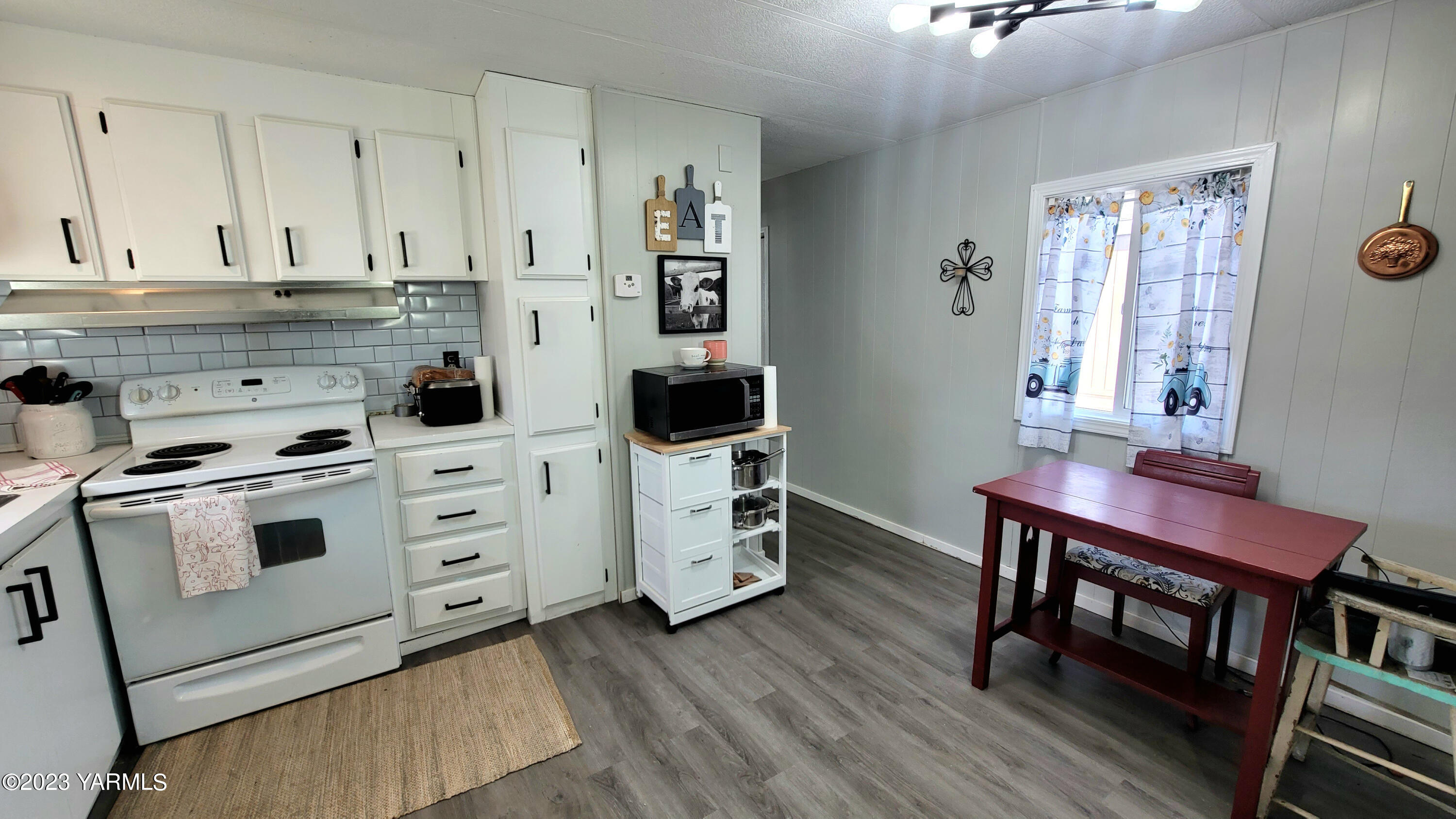 3005 Castlevale Road, Unit 26 Yakima, WA 98902 - Photo 4 of 12 a kitchen with stainless steel appliances a stove a sink and white cabinets