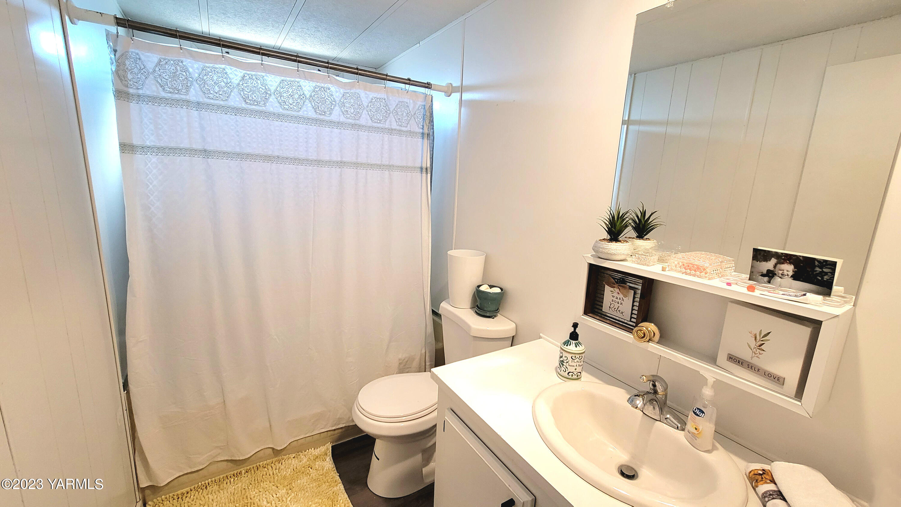 3005 Castlevale Road, Unit 26 Yakima, WA 98902 - Photo 9 of 12 a bathroom with a sink a toilet and shower curtain
