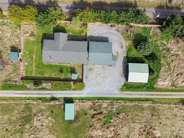 a view of a yard with wooden fence