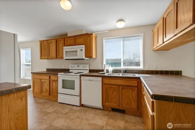 a kitchen with a refrigerator and a stove