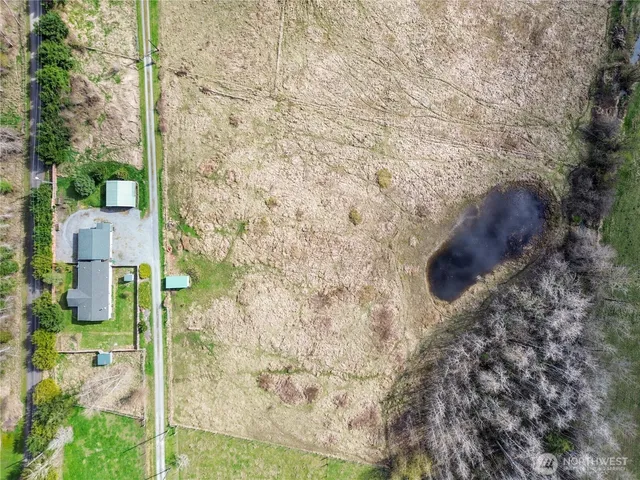 a view of a dry yard with wooden fence
