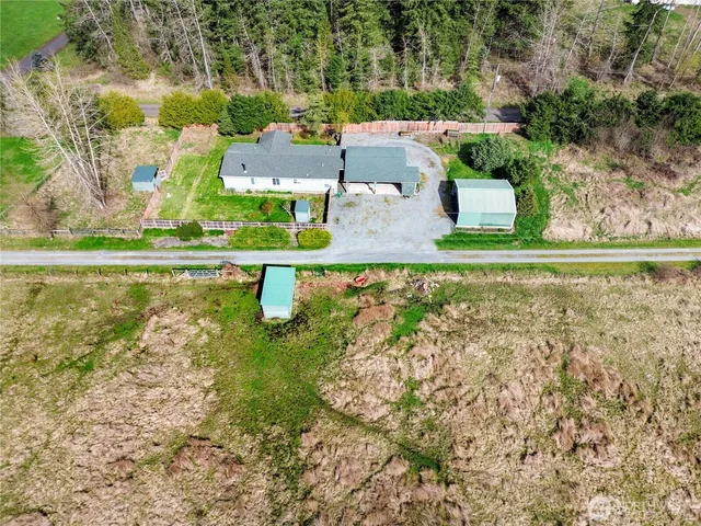 an aerial view of a house with a yard basket ball court and outdoor seating