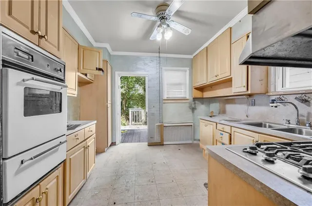 a kitchen with stainless steel appliances a stove a sink and a microwave