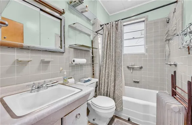 a bathroom with a sink toilet tub and shower