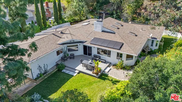 an aerial view of a house with a big yard